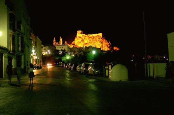 Via Verde de la Sierra village at night with castle lit up